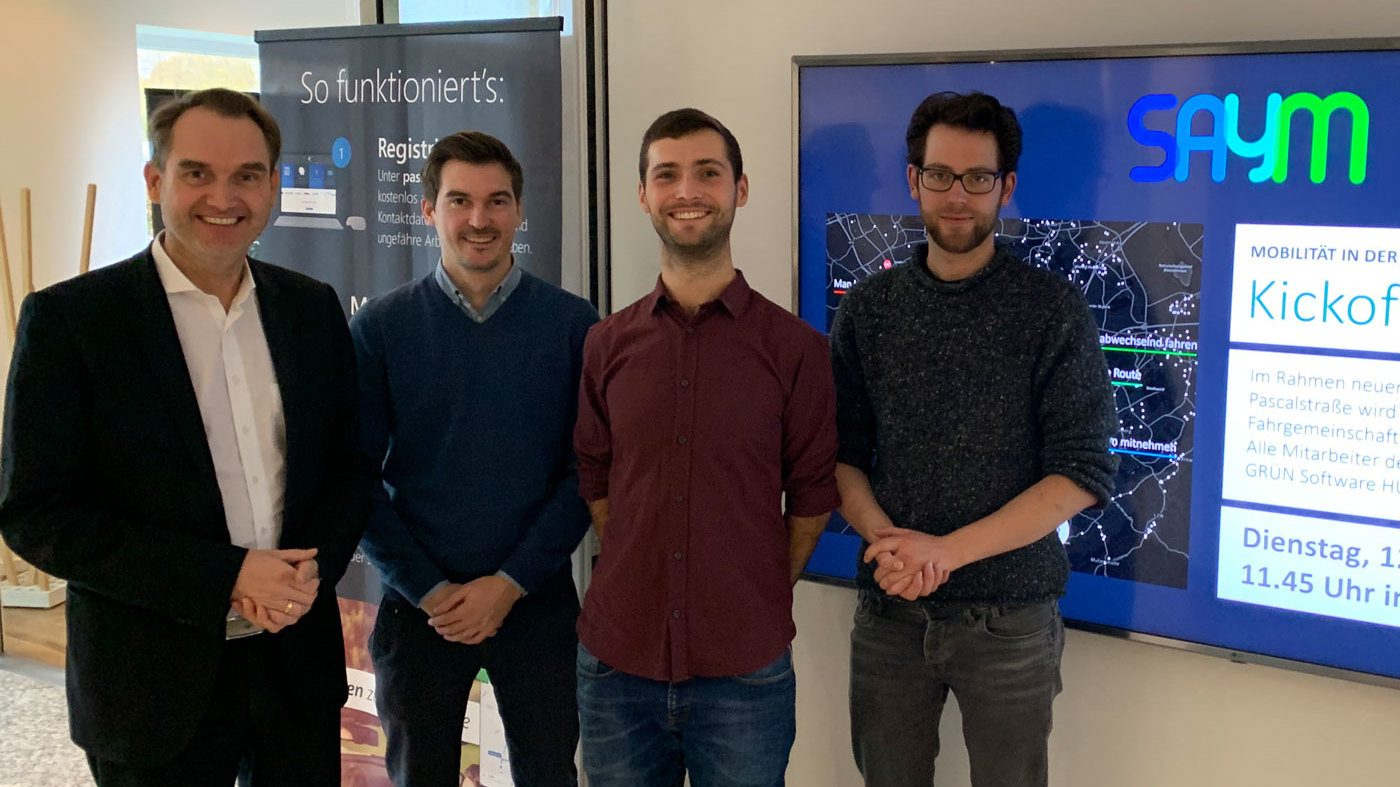 Dr. Oliver Grün, Vorstand und CEO der GRÜN Software AG mit Benjamin Dörries (COO), Daniel Bogdoll (CEO) und Philipp Uhl (UI/UX Design) von SAYM (v.l.n.r.).
